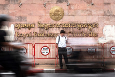 People walk past the Royal Embassy of Cambodia in Bangkok On July 24, 2025. A Cambodian rocket strike wounded three Thai civilians on July 24, 2025, the Thai army said, as the two sides clashed over a disputed border area.