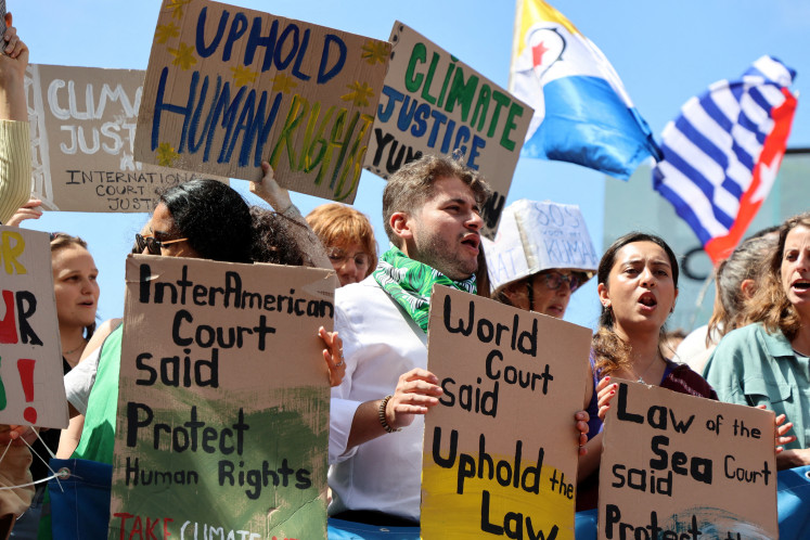 Climate activists and campaigners demonstrate outside the International Court of Justice (ICJ) ahead of the reading of an advisory opinion that is likely to determine the course of future climate action across the world, The Hague, Netherlands, July 23, 2025.