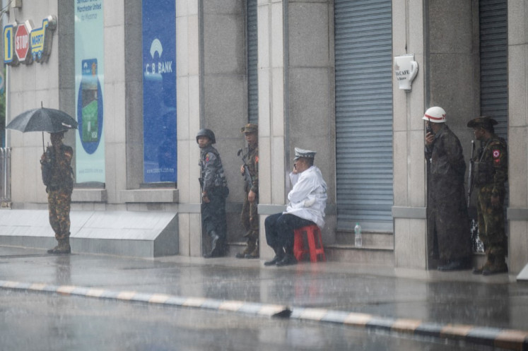 Members of Myanmar's military stand guard on a street in Yangon on July 19, 2025.