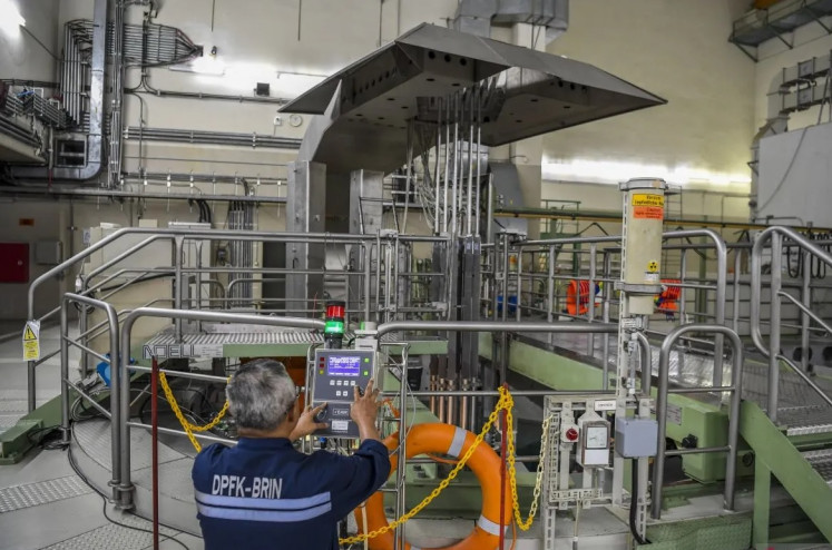 Handle it with care: A National Research and Innovation Agency (BRIN) researcher inspects a nuclear reactor pond on July 15 at G.A Siwabessy nuclear facility in the BJ Habibie Science and Technology Estate in Serpong, Banten.