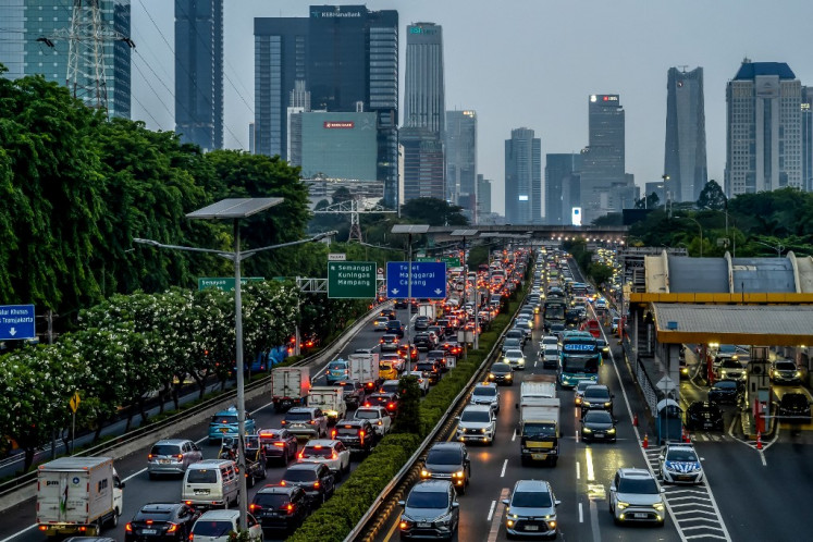 Vehicles crawl in bumper-to-bumper traffic along a major thoroughfare in Jakarta during the evening rush hour on Nov. 13, 2024.