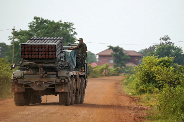 A Cambodian military personnel stands on a BM-21 Grad multiple rocket launcher, around 40 km from the disputed Ta Moan Thom temple, after Thailand and Cambodia exchanged heavy artillery on Friday as their worst fighting in more than a decade stretched for a second day, in Oddar Meanchey province, Cambodia, July 25, 2025. 