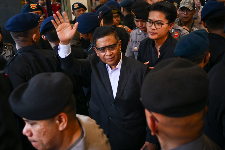 Indonesian Democratic Party of Struggle (PDI-P) secretary general Hasto Kristiyanto (center) waves to crowds after hearing the verdict for his trial at the Corruption Court, Jakarta, on July 25. The panel of judges found him guilty of bribery and sentenced him to three years and six months in prison and a fine of Rp 250 million. 