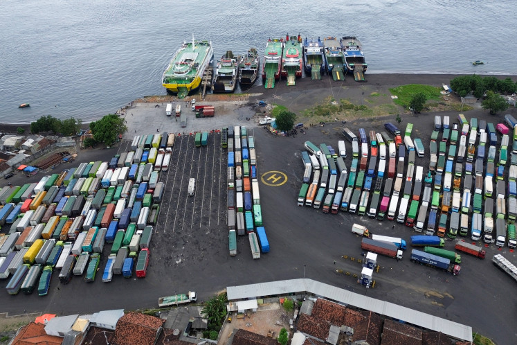 Freight trucks wait for their turn to board ferries at Bulusan Port in Banyuwangi, East Java, on July 25, 2025.