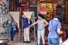 People vote at a local temple used as a polling station during the recall election in Taipei on July 26, 2025. Taiwanese voters turned out at schools, churches and community centers on July 26 to cast their ballot in a high-stakes recall election that could give President Lai Ching-te's party control of the parliament.