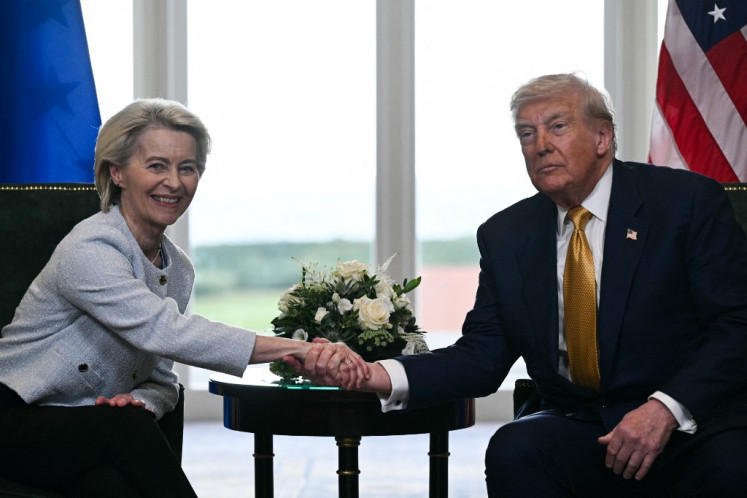 US President Donald Trump (right) shakes hands with European Commission President Ursula von der Leyen after agreeing on a trade deal between the two economies following their meeting, in Turnberry south west Scotland, on July 27, 2025.