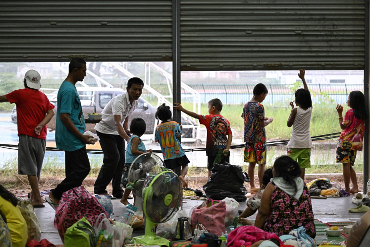 Evacuees rest at an evacuation center in the Thai border province of Surin on July 28, 2025. Thailand and Cambodia's leaders agreed to an “unconditional“ ceasefire on July 28, after five days of combat along their jungle-clad frontier that has killed at least 36 people.
