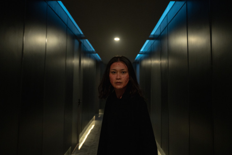 Questionable identity: Marissa Anita, as the protagonist Milla, appears in a still image from director Lucky Kuswandi’s ‘A Normal Woman’. (Courtesy of Netflix)
