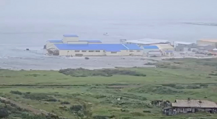 A powerful wave washes past a building located near the shore, after a powerful earthquake struck off the Kamchatka Peninsula, in Severo-Kurilsk, Sakhalin Region, Russia July 30, 2025 in this screen grab obtained from social media video. 