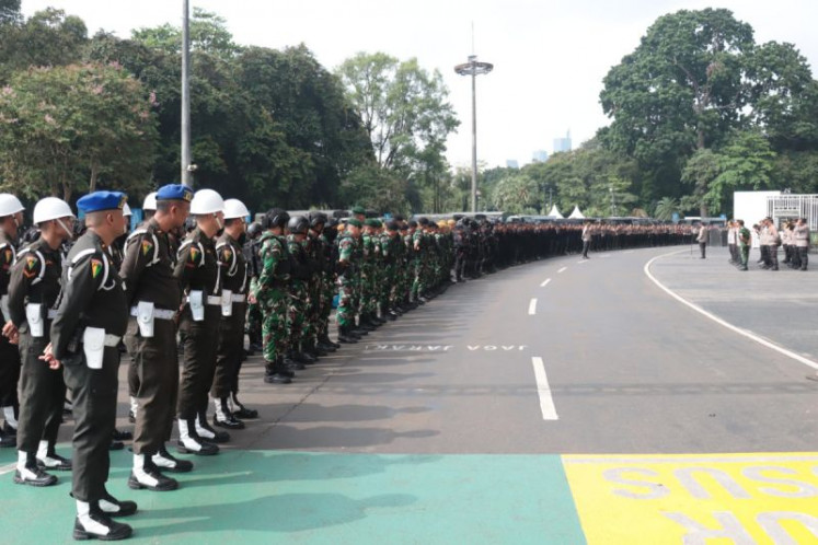 Joint security officers stand at the ready on July 29 during a briefing ahead of the 2025 ASEAN U-23 Championship final match between Indonesia and Vietnam at the Gelora Bung Karno (GBK) Main Stadium in Jakarta. Vietnam won the championship after defeating Indonesia 1-0.