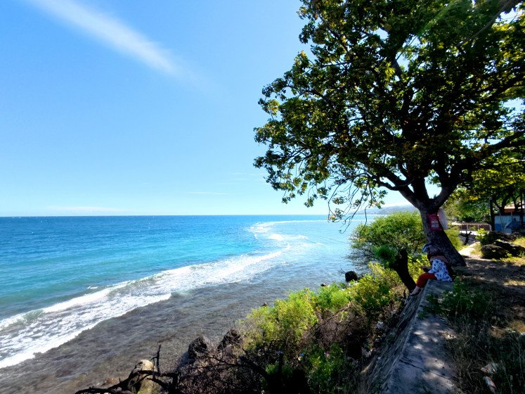 A resident watches the ocean on July 30 in South Leato beach in Gorontalo city, Gorontalo, as the Meteorology, Climatology and Geophysics Agency (BMKG) issues a tsunami advisory for the city after a magnitude 8.8 earthquake hit the Kamchatka Peninsula in far eastern Russia.