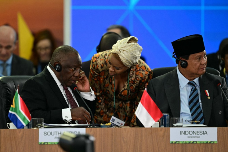South Africa's President Cyril Ramaphosa (left) talks with an advisor next to  President Prabowo Subianto during a plenary session of the BRICS summit in Rio de Janeiro, Brazil, on July 7, 2025.