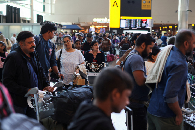 Passengers wait at Heathrow Airport, after radar failure led to the suspension of outbound flights across the UK, in Hounslow, London, Britain, July 30, 2025.