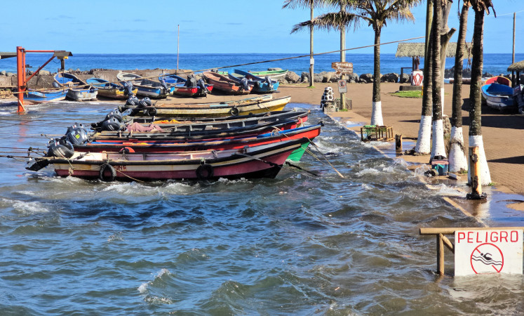 Waves hit boats moored at the dock during a tsunami warning in Easter Island, Chile on July 30, 2025. Chile warned on July 29, 2025, of a “high probability“ of a tsunami in the country as a result of an 8.8 magnitude earthquake off the coast of Russia, the Navy reported.