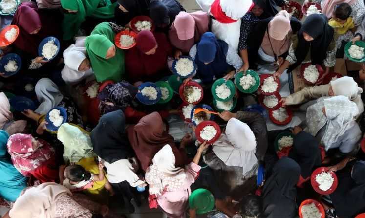 Peace and prosperity: Local people queue for traditional food during a gathering to mark the 20th anniversary of devastating tsunami at Lampulo fish port in Banda Aceh, the capital of Aceh, on Dec 26, 2024. The disaster accelerated the peace negotiation to end decades of armed conflict plaguing the province.