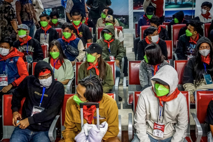 Finally free: Indonesian victims of human trafficking in Myanmar arrive from Thailand on Feb. 28 at the Soekarno-Hatta International Airport in Tangerang, Banten, following their handover by the Myanmar government to Thailand. Myanmar handed over 84 Indonesians to Thailand on Feb. 27, officials said, the latest group of alleged scam center workers set to be repatriated from the region.
