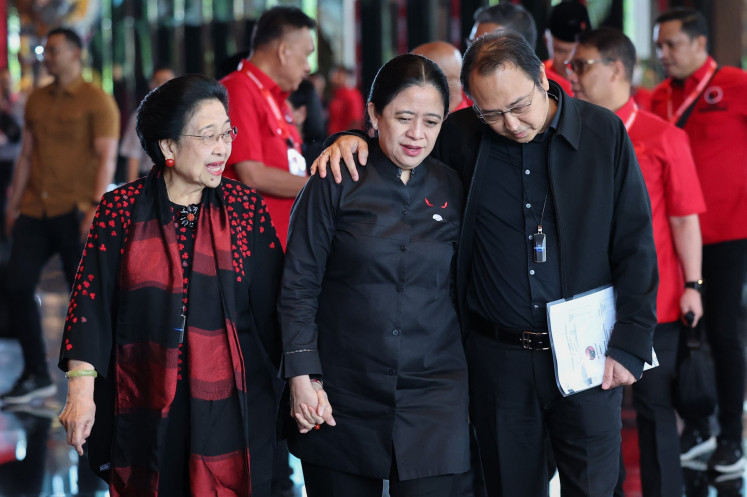 Keeping the flame: Indonesian Democratic Party of Struggle (PDI-P) chair Megawati Soekarnoputri (left) walks with party executives and her daughter Puan Maharani (center) and son M. Prananda Prabowo (right) upon entering the venue for the party's technical briefing on Wednesday in Denpasar, Bali. The event was held just days before the congress that reelected Megawati as party chairwoman.