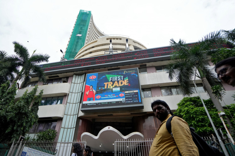 People walk past the Bombay Stock Exchange (BSE) building in Mumbai, India, on Aug. 1, 2025.