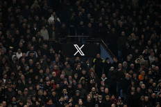 The logo for social media network X, formerly Twitter, is pictured displayed on a screen in the stands during the English FA Cup fifth round soccermatch between Aston Villa and Cardiff City at Villa Park in Birmingham, central England on Feb. 28, 2025.