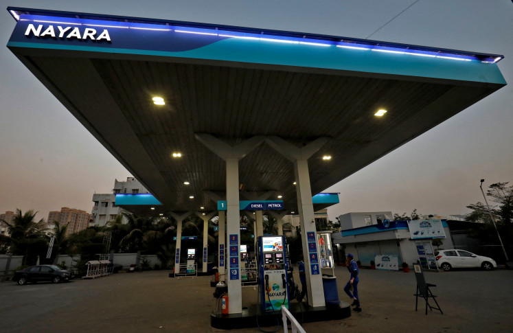 A worker stands at a fuel station of Nayara Energy on the outskirts of Ahmedabad, India, on Nov. 16, 2022.