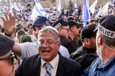 Israeli policemen surround Israeli Minister of National Security and far-right politician Itamar Ben-Gvir as he arrives outside the Damascus Gate of the walled Old City of Jerusalem on May 26, 2025, during a flag march for Jerusalem Day, commemorating the Israeli army's 1967 capture of the city's eastern sector during the Arab-Israeli war. 