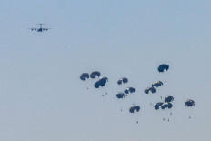 A German Air Force (Luftwaffe) A400M Atlas military transport aircraft releases aid pallets while flying over Nuseirat in the central Gaza Strip during an airdrop mission above the Israel-besieged Palestinian territory on August 4, 2025. 