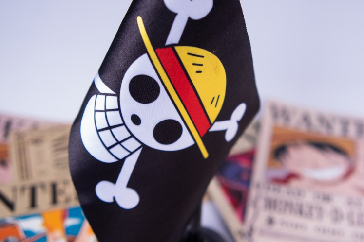 Creative expression: The “Jolly Roger“ flag from Japanese anime 'One Piece' is pictured along with several wanted posters from the show in this undated photo.