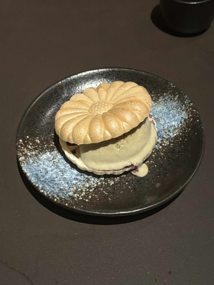 The hojicha ice cream sandwich surprises with a burst of blueberry jam, tucked between crisp rice crackers.