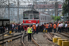Demanding attention: Officers evacuate a derailed Commuter Line train on the Bogor–Jakarta route on Tuesday at the Jakarta Kota Station train yard.