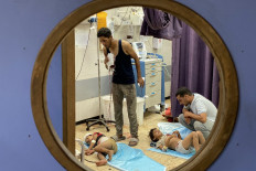 Palestinian children receive medical attention at the Nasser Medical Complex in Khan Yunis in the southern Gaza Strip on August 7, 2025, following Israeli bombardment on the Mawasi area of Khan Yunis. 