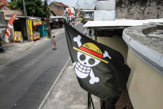 A pirate flag from the Japanese anime 'One Piece',installed a week earlier to follow an internet trend using the symbol to criticize government policies, is seen at a house in Surakarta, Central Java, on Aug. 7, 2025, ahead of Indonesia's 80th Independence Day. As Indonesia's independence day approaches, red-and-white flags will be flown across the country, but a viral anime pirate banner has drawn government threats against flying the swashbuckling ensign. 
