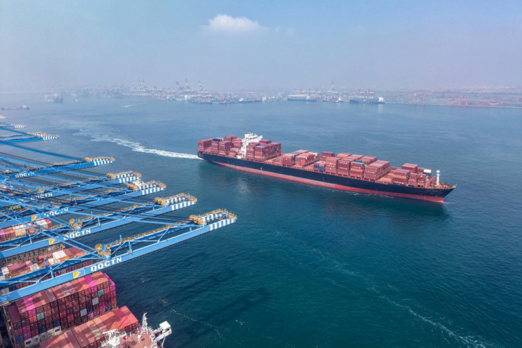 A container ship sails out of port on Aug. 7 in Qingdao, in China's eastern Shandong province . 