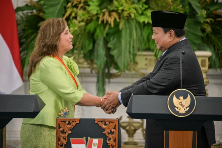Peru's President Dina Boluarte (left) and Indonesia's President Prabowo Subianto shake hands during a joint press conference following their meeting at the Merdeka Palace in Jakarta on August 11, 2025. 