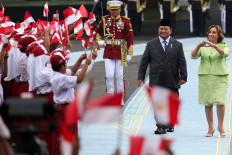 President Prabowo Subianto and visiting Peru's President Dina Boluarte inspect the honor guard during a welcoming ceremony on Aug. 11 upon their meeting at the Merdeka Palace in Jakarta.