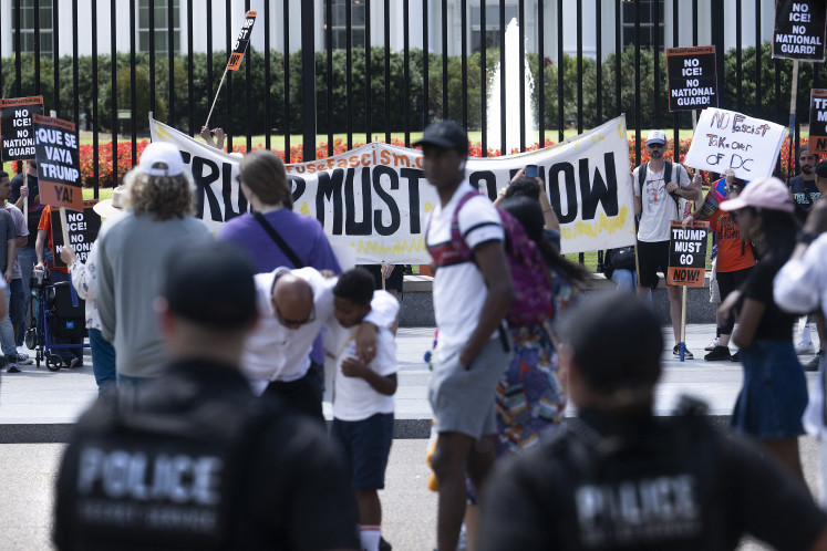 US Secret Service uniformed officers look on as demonstrators rally against US President Donald Trump's plans to activate federal law enforcement in Washington, DC, on August 11, 2025. President Donald Trump announced Monday that he was deploying National Guard troops and putting the Washington police force under federal control to tackle crime in the US capital. “This is Liberation Day in DC, and we're going to take our capital back,“ Trump said at a White House press conference.