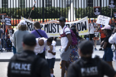 US Secret Service uniformed officers look on as demonstrators rally against US President Donald Trump's plans to activate federal law enforcement in Washington, DC, on August 11, 2025. President Donald Trump announced Monday that he was deploying National Guard troops and putting the Washington police force under federal control to tackle crime in the US capital. “This is Liberation Day in DC, and we're going to take our capital back,“ Trump said at a White House press conference.