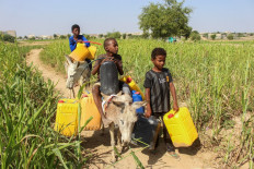 Children carrying containers arrive to refill them with water from a distribution point at a camp for the internally displaced in Yemen's northern Abs district of the Hajjah governorate on Jan. 9, 2025, as the humanitarian crisis in the country continues following the onset of the civil war in 2014.