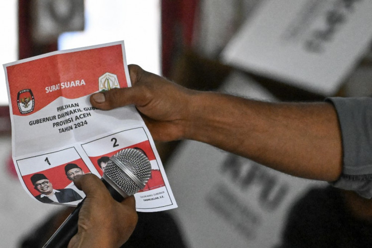 An election staffer counts ballots at a polling station on Nov. 27, 2024, in Banda Aceh, Aceh. More than 200 million people voted to choose dozens of governors, mayors and regents in the simultaneous regional elections.