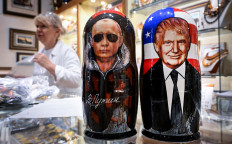 Traditional Russian wooden nesting dolls, Matryoshka dolls, depicting Russian President Vladimir Putin and US President Donald Trump are displayed for sale at a gift shop on the touristic Arbat street in downtown Moscow on August 13, 2025, a few days before Putin-Trump meeting in Alaska. The summit planned in Alaska reminds some of the great moments of détente between the USSR and the United States, when Soviet and American leaders found themselves alone to decide the course of the world.