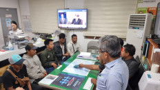Safe and sound: Korean authorities check the identities of eight Indonesian crew members after they were rescued by the Korea Coast Guard at an undisclosed location in this undated picture released by the Indonesian Maritime Security Agency (Bakamla) on Wednesday. The eight crew members noted odd occurrences after they were placed on board a ship owned by a South Korean company, leading to suspicions they could be victims of human trafficking.