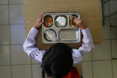 A student eats lunch on the first day of a free-meal programme at an elementary school in Bogor, West Java, on January 6, 2025. 