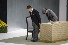 Japan's Emperor Naruhito (left) and Empress Masako bow as they arrive at a memorial service marking the 80th anniversary of Japan's surrender in World War II at the Nippon Budokan hall in Tokyo, Japan on Aug. 15, 2025.