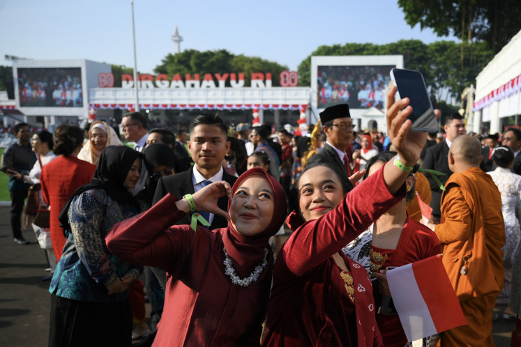 Attendants take a selfie on Aug. 17 ahead of the annual flag-hoisting ceremony to commemorate the 80th Independence Day at the Merdeka Palace in Jakarta.