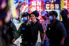 Pro-democracy legislator Ted Hui (center) is detained by police during a pro-democracy rally in the Causeway Bay district of Hong Kong on June 12, 2020. Former pro-democracy Hong Kong lawmaker Ted Hui, who is wanted by the Chinese city, has been granted asylum in Australia, he said in a social media post in mid August 2025, calling on Canberra to do more for those who remain jailed.