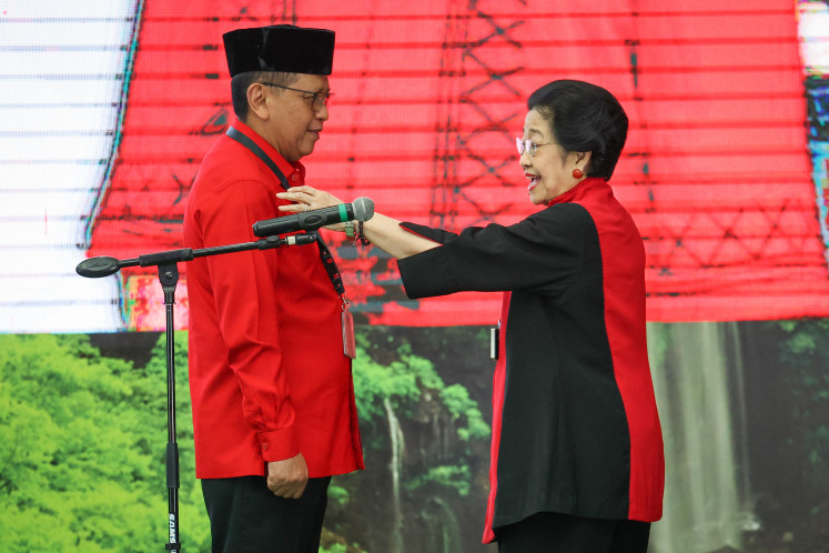 Making his return: Indonesian Democratic Party of Struggle (PDI-P) chairwoman Megawati Soekarnoputri (right) speaks with Hasto Kristiyanto on Thursday at party headquarters in Jakarta, following his reappointment as the party's secretary-general. In addition to Hasto's reappointment to one of the most strategic positions in the party, Megawati also announced the new lineup of party executives.