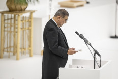 Japan's Prime Minister Shigeru Ishiba delivers a speech during a memorial service marking the 80th anniversary of Japan's surrender in World War II at the Nippon Budokan hall in Tokyo on Aug. 15, 2025. 