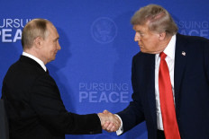United States President Donald Trump (right) and Russian President Vladimir Putin shake hands at the end of their press conference on Aug. 15, 2025, following the US-Russia summit on the Ukraine war at Joint Base Elmendorf-Richardson in Anchorage, Alaska.