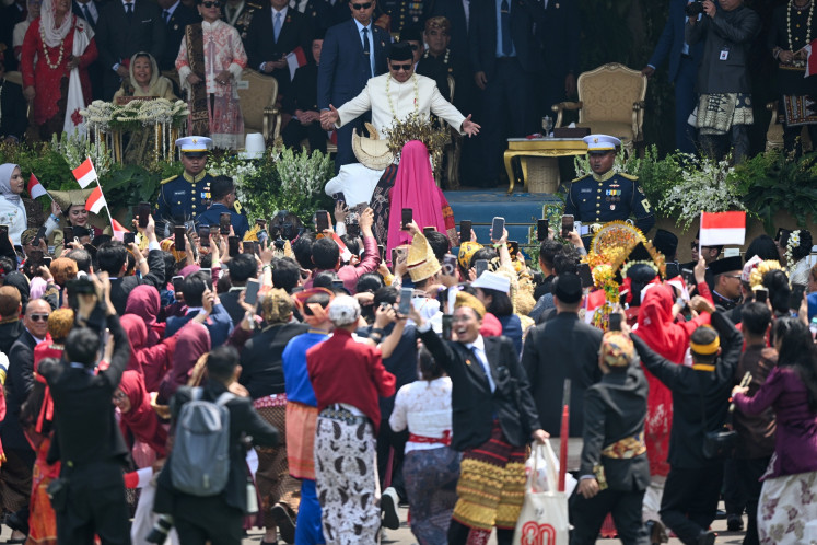 President Prabowo Subianto (center, wearing white) greets ceremony attendants in the middle of the cultural performance after the flag-hoisting ceremony to commemorate the 80th anniversary of the Independence Day at the State Palace in Jakarta on Aug. 17, 2025.