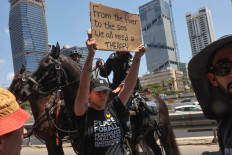 A demonstrator raises a placard during an anti-government protest demanding a deal to release Israelis detained in the Gaza Strip by Hamas militants since October 7, 2023, in Tel Aviv on August 17, 2025 Demonstrators took to the streets across Israel on August 17, 2025, more than a week after Israel's security cabinet approved plans to capture Gaza City and nearby camps, following 22 months of war that have created dire humanitarian conditions.