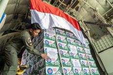 Ready to fly: An Air Force soldier checks humanitarian aid inside a Hercules C-130 plane on Aug. 13 during the send-off of the Red-and-White Task Force II mission to deliver aid to Gaza, at Halim Perdanakusuma Air Base, Jakarta.